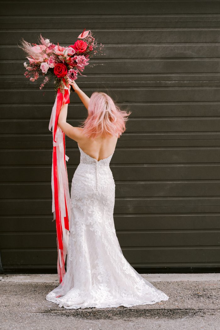 Real Bride Wearing Strapless Mermaid Wedding Gown Called Kaysen by Maggie Sottero and Holding Pink Bouquet