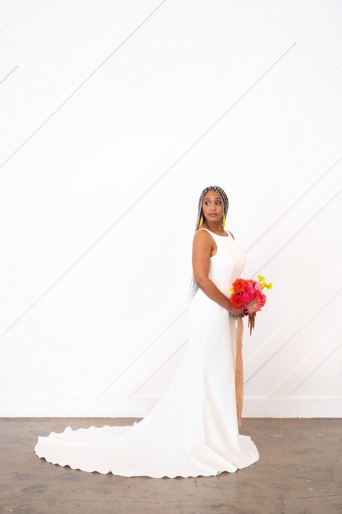 Bride Holding Colorful Bouquet and Wearing White Minimalist Wedding Dress Called Claudia Dawn by Maggie Sottero