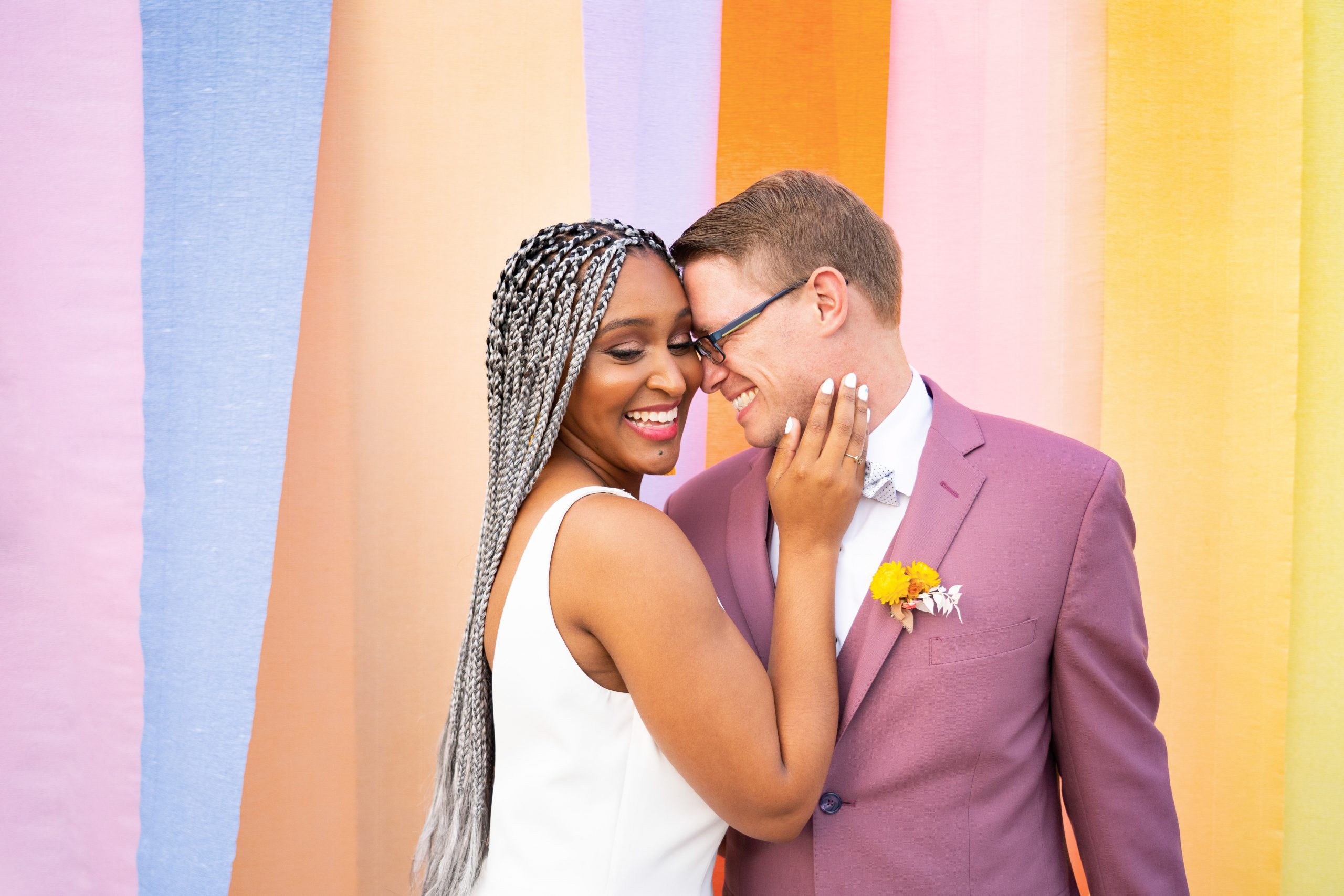 Interracial Couple Kissing in Front of Color Block Background at Citrus Wedding