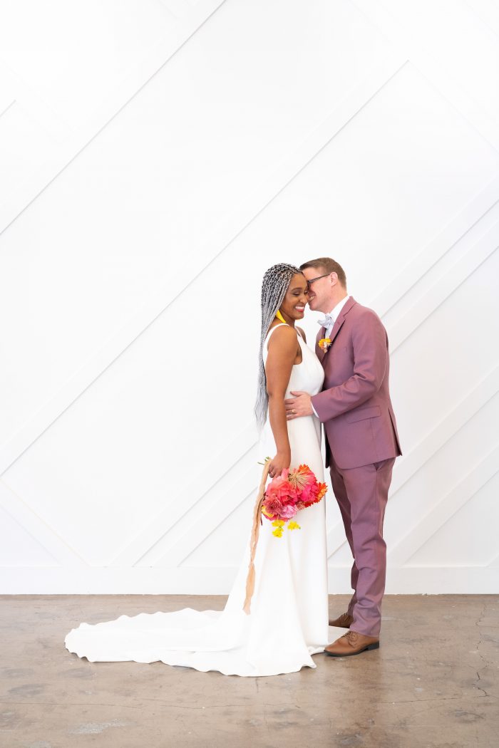 Groom Kissing Real Bride Wearing Crepe Sheath Wedding Dress Called Claudia Dawn by Maggie Sottero