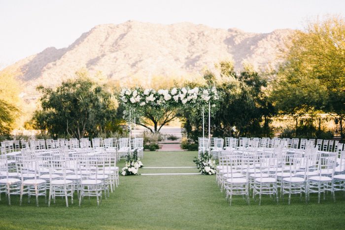Clean Wedding with Archway Featuring Green and White Florals