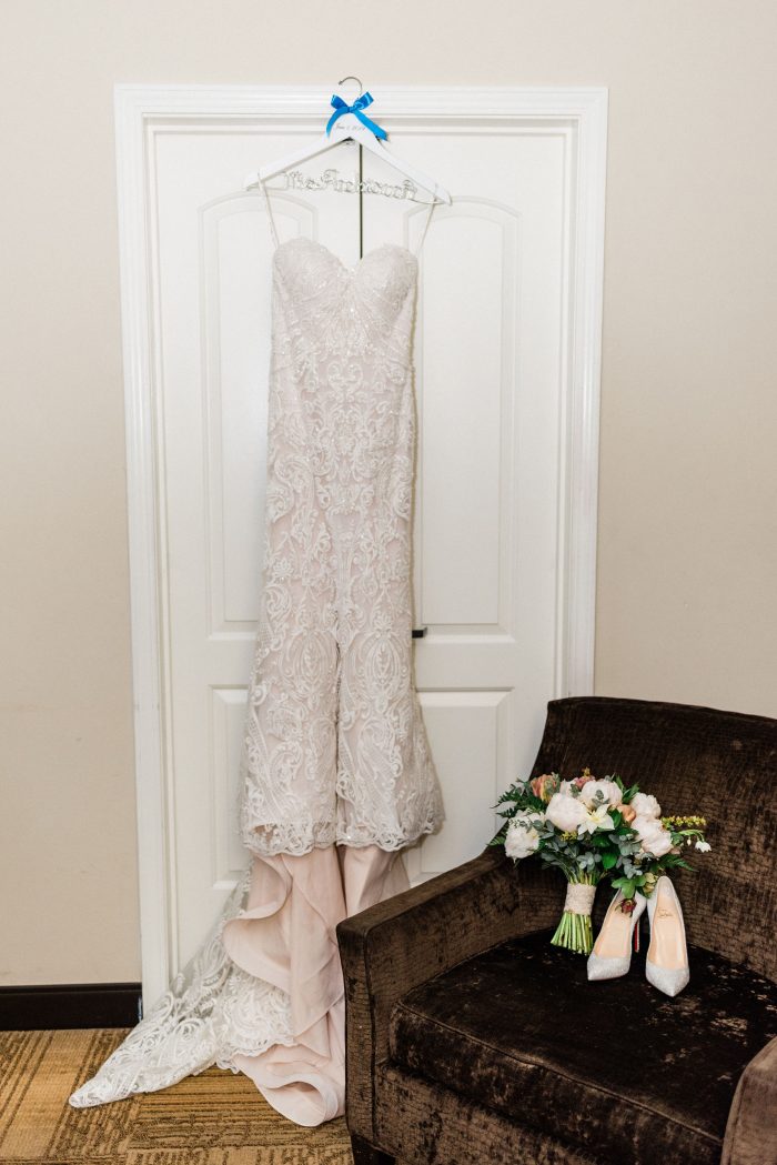 Strapless Wedding Dress by Sottero and Midgley Hanging on Door by Blue Closed Toed Wedding Shoes