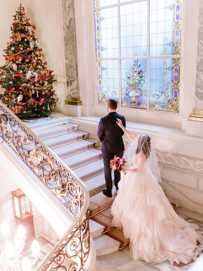 Groom with Real Bride by Christmas Tree Wearing Holiday Wedding Dress Called Timbrey by Maggie Sottero