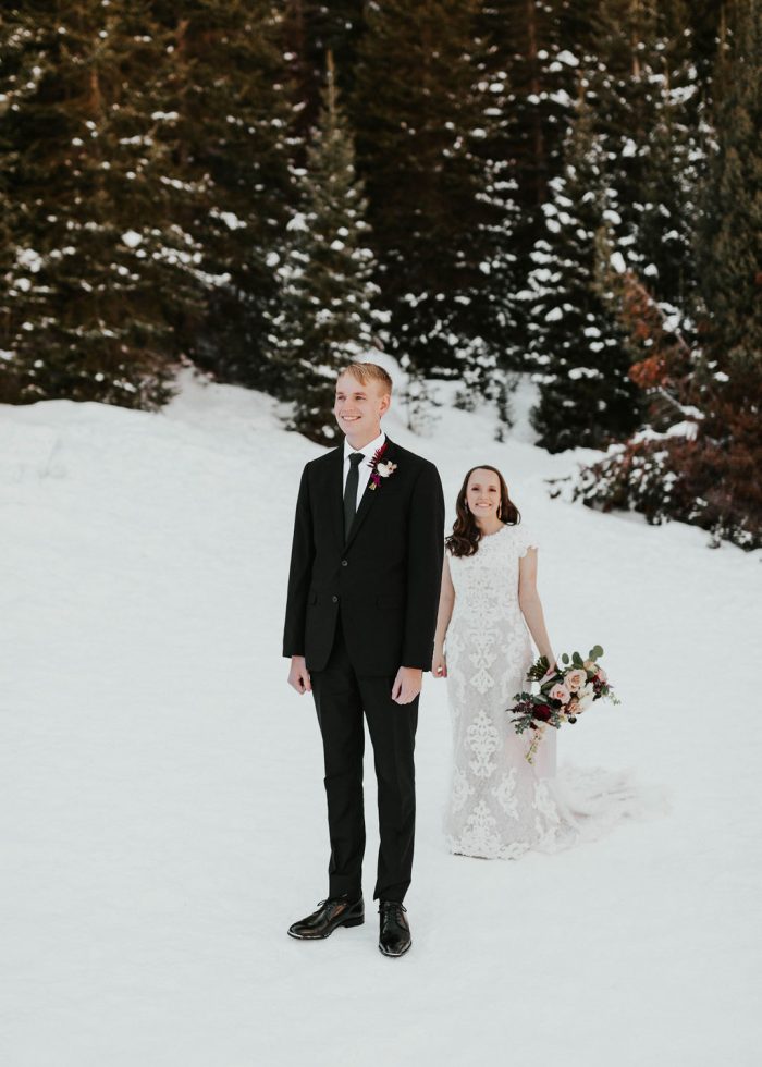 Groom During First Look with Bride Wearing Modest Sleeved Wedding Dress in the Snow