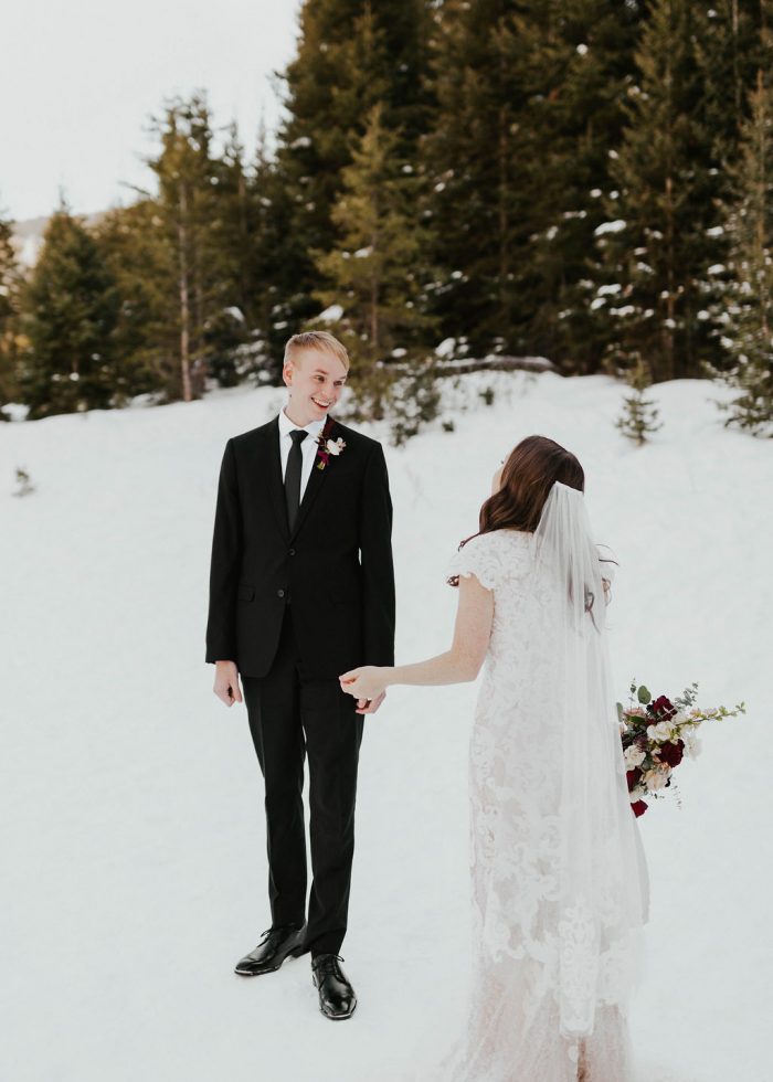 Bride Turning Groom Around During First Look and Wearing Modest Winter Wedding Dress Called Tuscany Leigh by Maggie Sottero