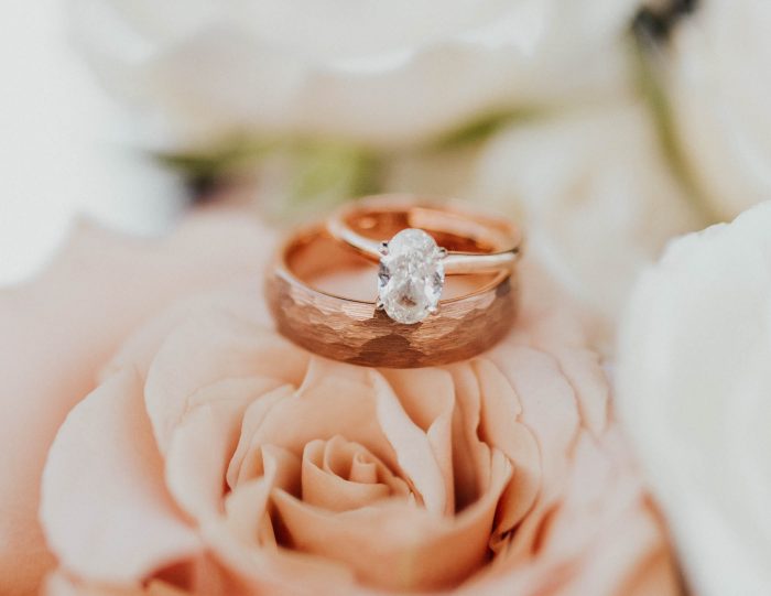 Rose Gold Wedding Rings on Top of Rose Wedding Bouquet