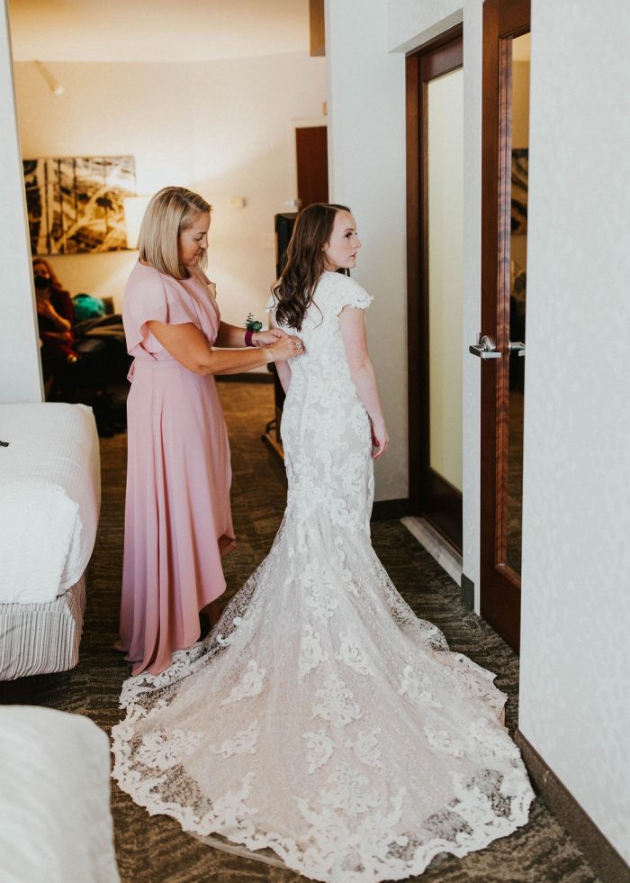 Mother of the Bride Dressing Bride in Modest Wedding Dress Called Tuscany Leigh by Maggie Sottero