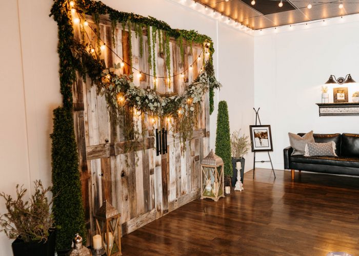Rustic Chic Wedding Venue with Barn Doors, Hanging Lights, and Greenery