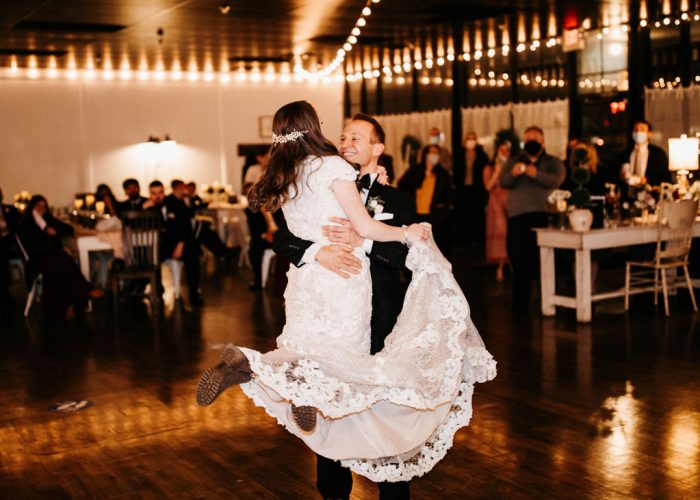 Father of Bride Picking Up Bride During Choreographed Father-Daughter Dance at Rustic Wedding