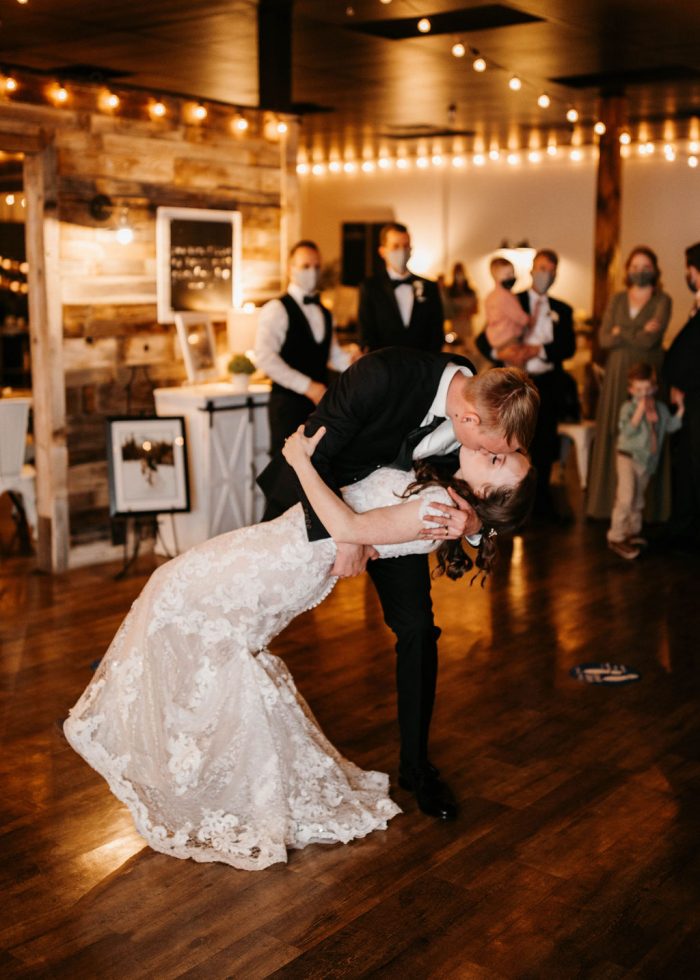 Groom Dipping Bride during First Dance at Rustic Wedding Reception