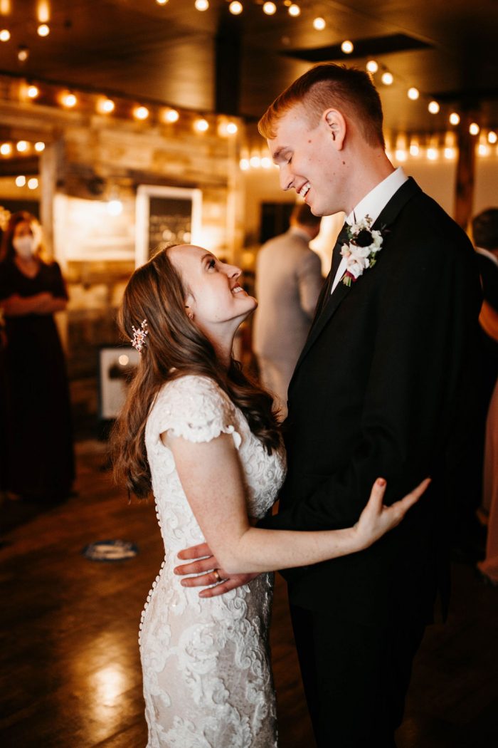 Groom Dancing with Real Bride Wearing Modest Cap-Sleeve Wedding Dress called Tuscany Leigh by Maggie Sottero at Rustic Winter Wedding