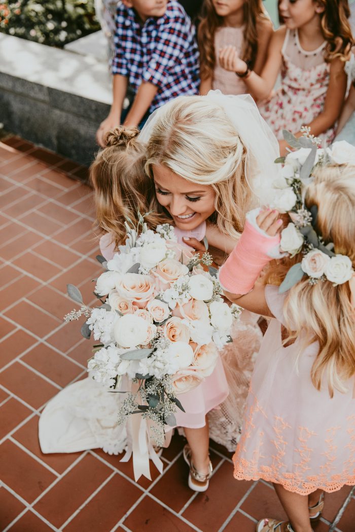 Real Bride Wearing Maggie Sottero Wedding Dress Hugging Flower Girls