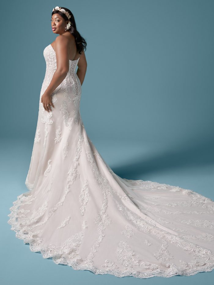 Plus Size Model Wearing Plus Size Strapless Wedding Dress with Extended Train Called Clarette Anne by Maggie Sottero