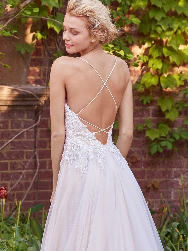 Beautiful statement-back wedding dresses from Maggie Sottero and Sottero and Midgley - SFlirty strap details create a crisscross effect that accents the open plunging back in this tulle A-line wedding dress. Marjorie by Rebecca Ingram.