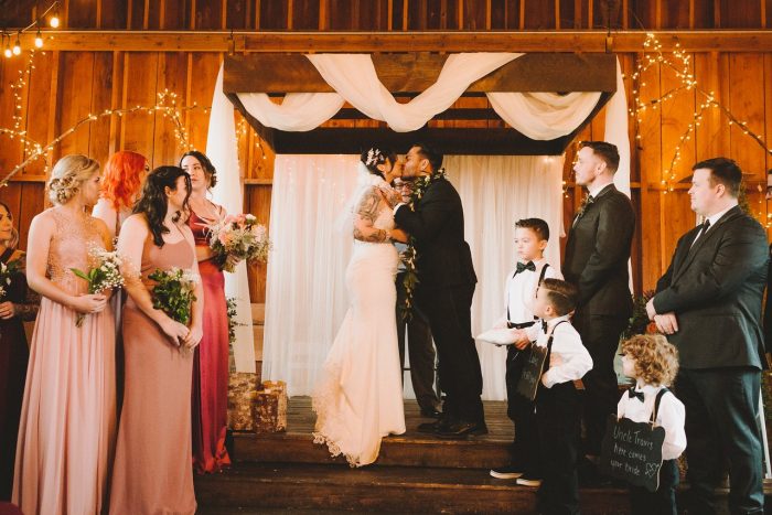 Real Bride Wearing Beaded Sheath Wedding Dress and Groom Kissing After Wedding Cerermony