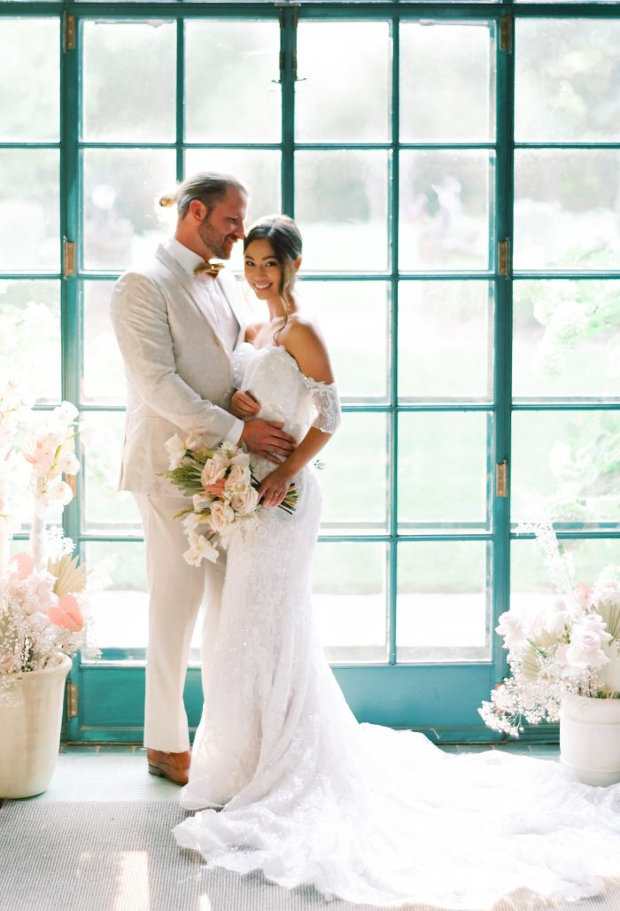 Groom with Bride Wearing Shimmery Boho Wedding Gown Called Conrad by Sottero and Midgley