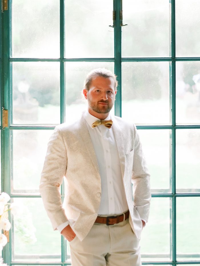 Groom Wearing Tan Suit with Bow Tie for Boho Styled Shoot