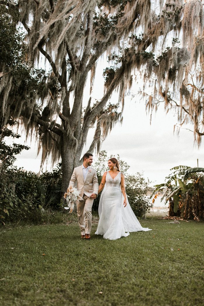 Bride Walking with Real Bride Wearing Sparkly Sheath Wedding Dress Called Elaine by Maggie Sottero
