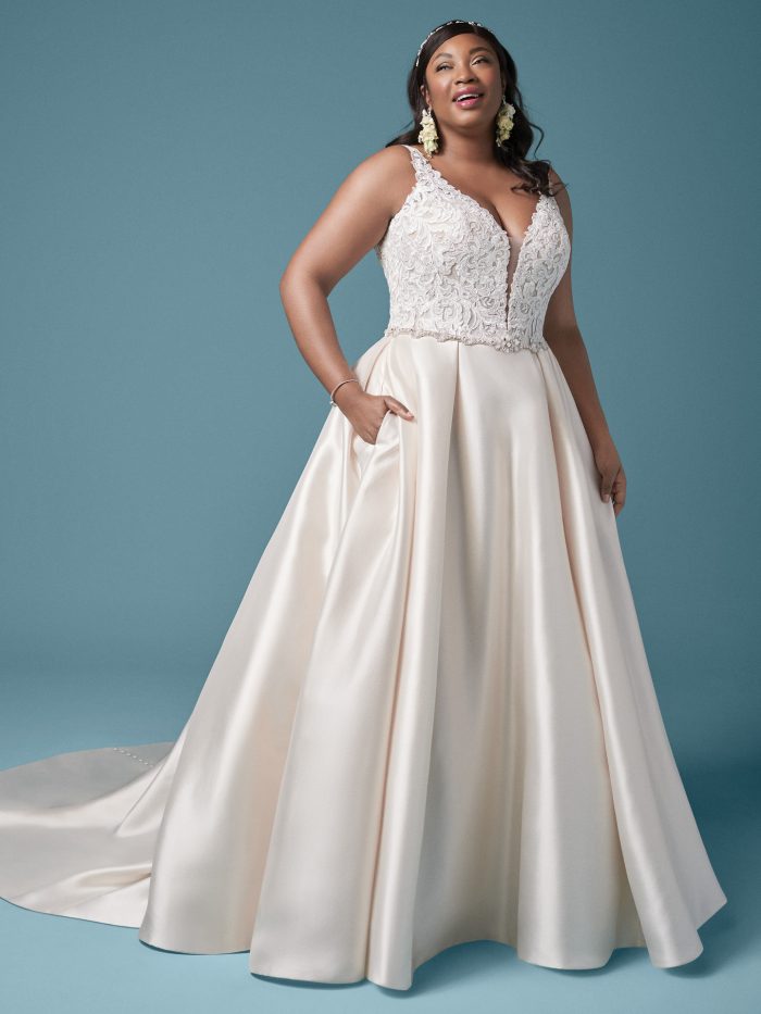 Plus Size Model Wearing Plus Size Satin Princess Wedding Gown Called Sonnet by Maggie Sottero