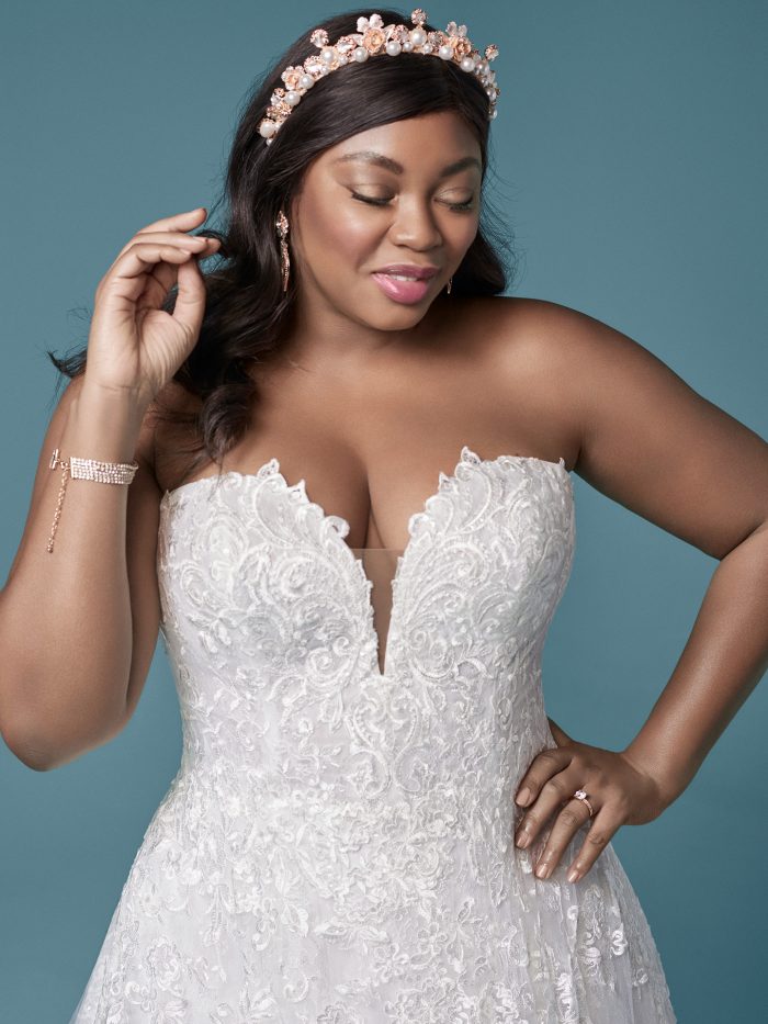 Curvy Model Wearing Plus Size Strapless Ball Gown Wedding Dress Called Tennyson by Maggie Sottero