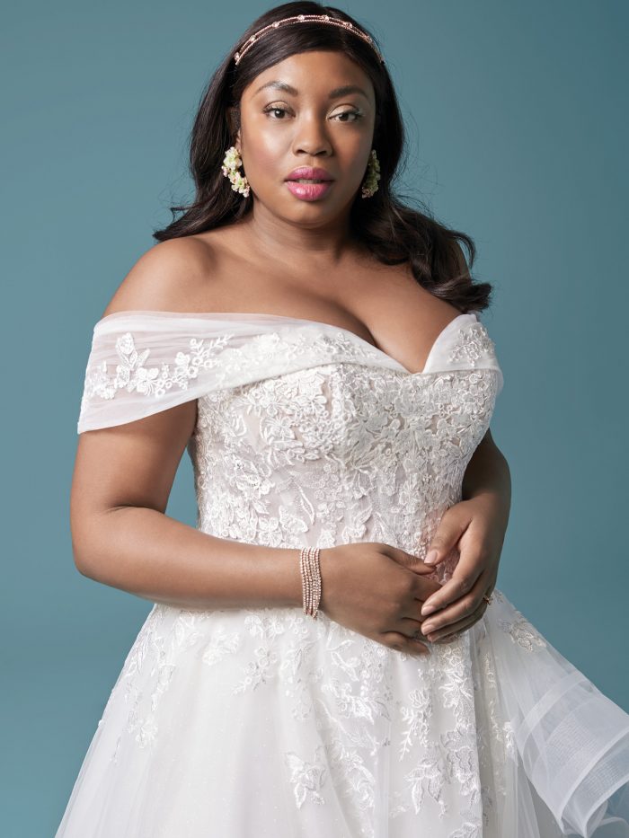 Plus Size Model Wearing Curvy Off-the-Shoulder Wedding Dress Called Zariah by Maggie Sottero