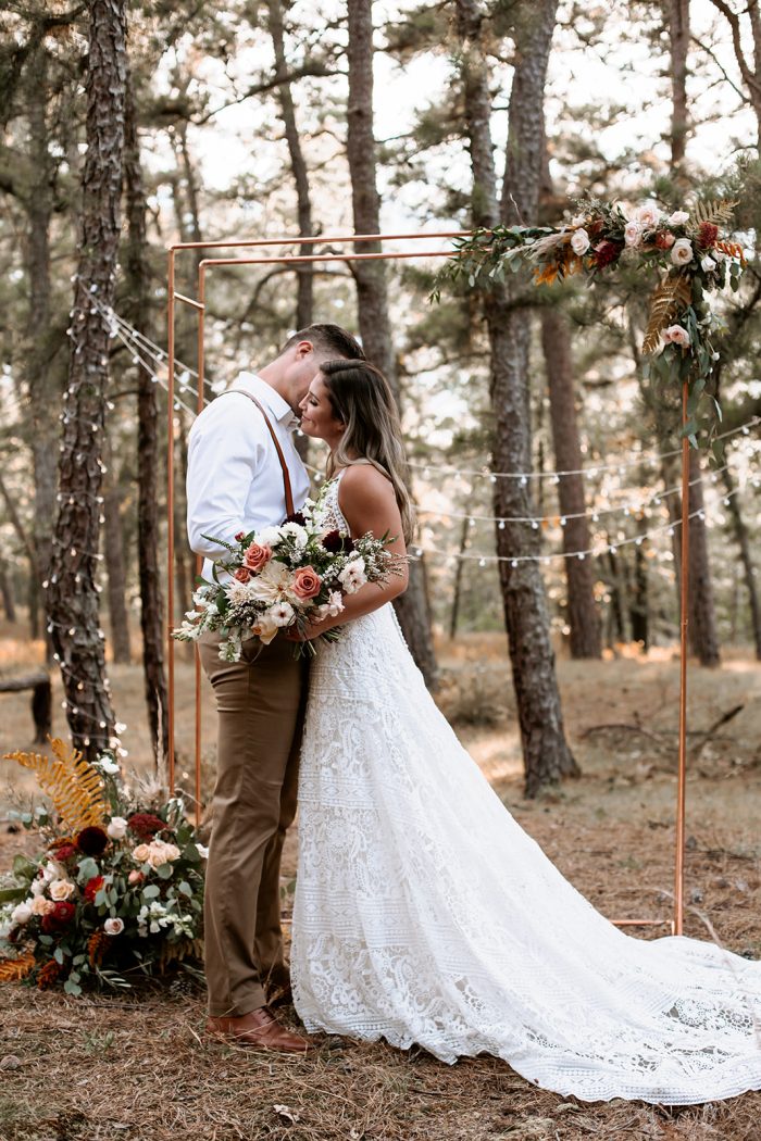 Groom Kissing Bride Wearing Boho Lace A-line Wedding Gown Called Finley Dawn by Sottero and Midgley at Outdoor Wedding