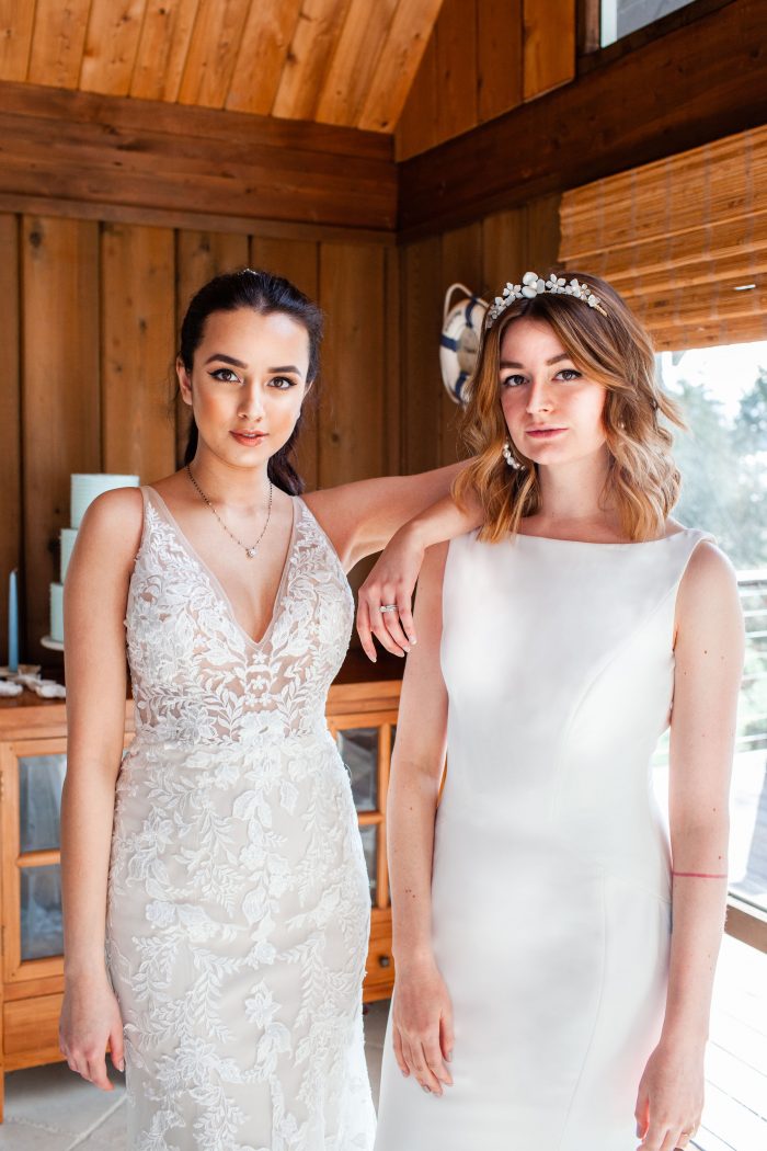Two Models Wearing Beach Wedding Dresses by Maggie Sottero in Beach Venue