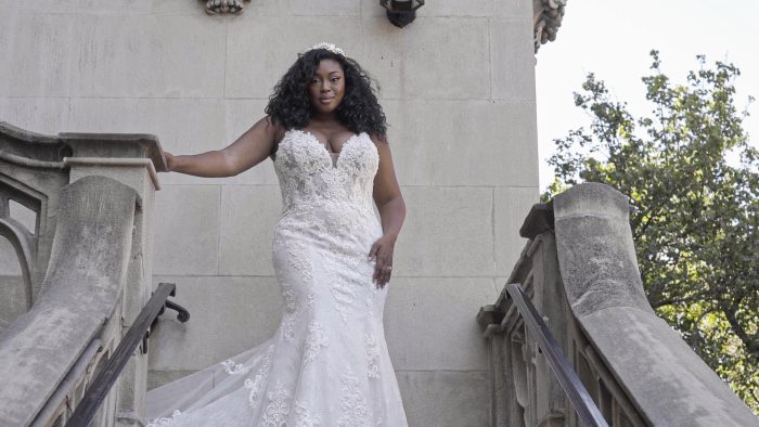 Black Plus Size Model Wearing Curvy Fit-and-Flare Wedding Dress Called Farrah by Maggie Sottero