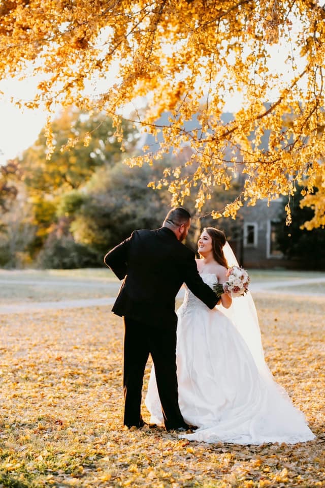 Bride Standing In Autumn Field Wearing A Balllgown Wedding Dress Caleld Kimora By Sottero And Midgley Standing With Husband