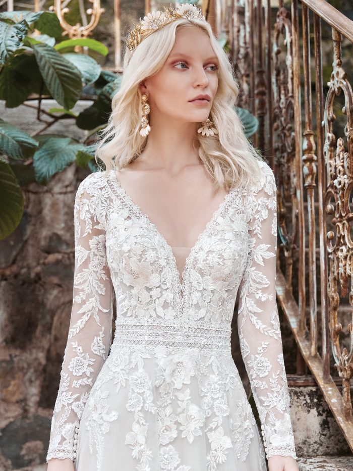 Model Wearing Floral Illusion Sleeve A-line Wedding Dress Called Raphael by Maggie Sottero