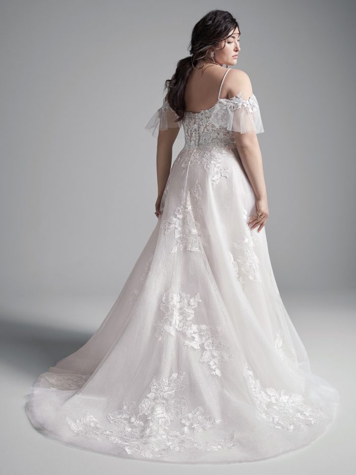 Plus Size Model Wearing Plus Size Cold Shoulder Floral Lace A-line Wedding Gown Called Houston by Sottero and Midgley