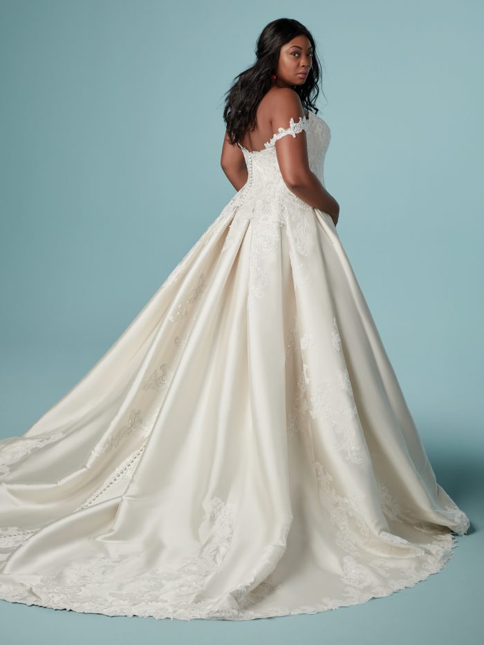 Curvy Black Bride Wearing Off-the-Shoulder Satin Ball Gown Wedding Dress Called Sheridan by Maggie Sottero
