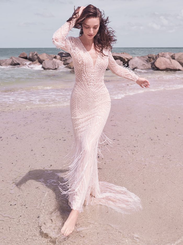 Model on Beach Wearing Art Deco Wedding Dress with Fringe Called Andrew by Sottero and Midgley