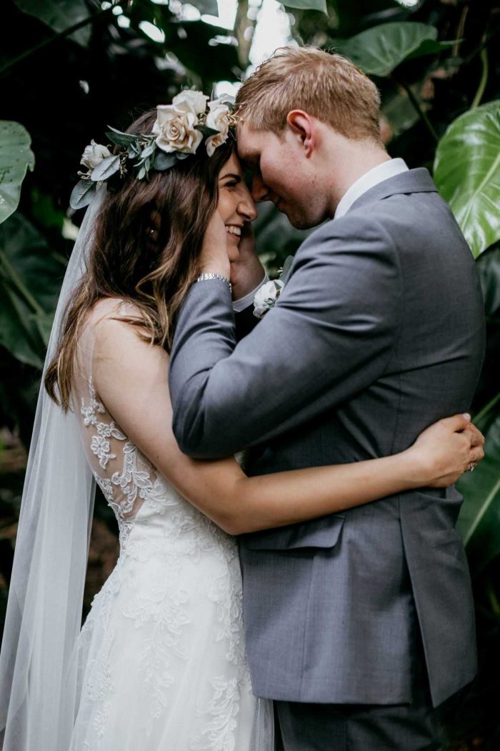 Groom Hugging Real Bride Wearing Boho Flower Crown and Floral Lace Wedding Dress Camille by Rebecca Ingram