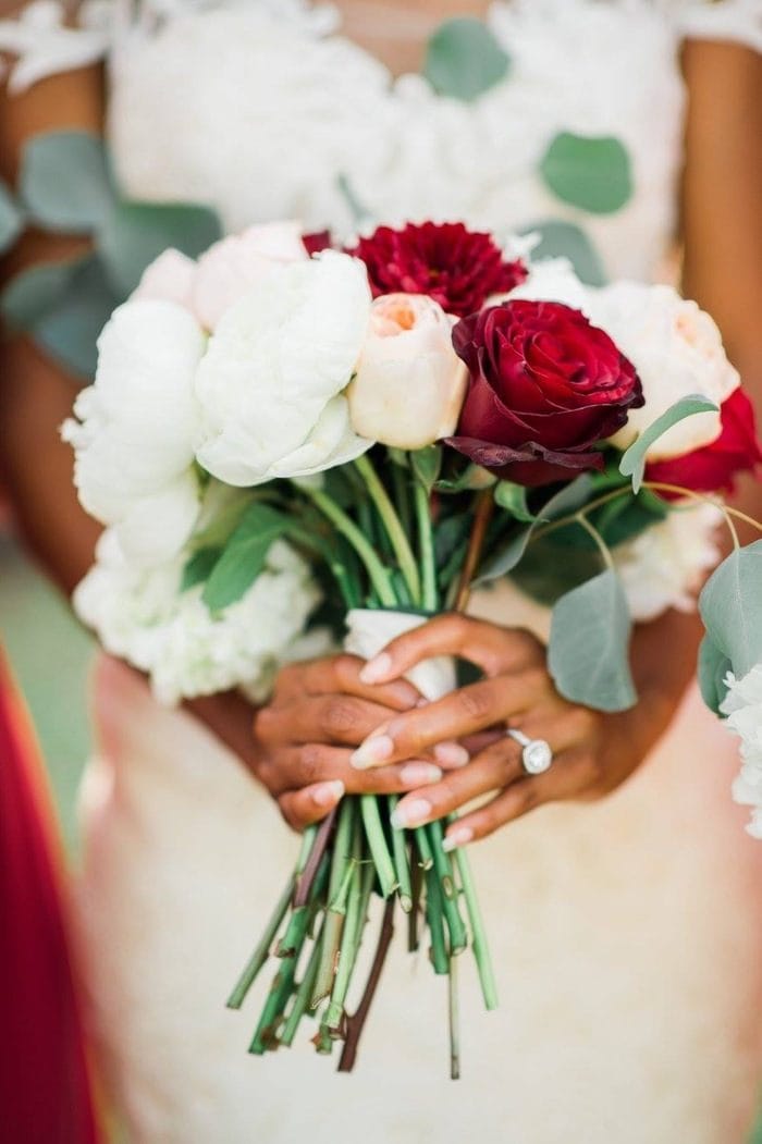 Bride Holding Bouquet of Red and White Roses