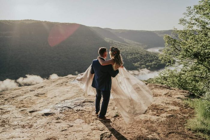 Groom Carrying Real Bride in Intimate Mountain Elopement in Tennessee