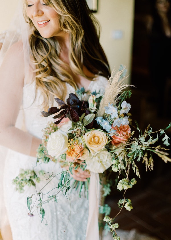 Real Bride Holding Bouquet of Roses in Tuscany Italy