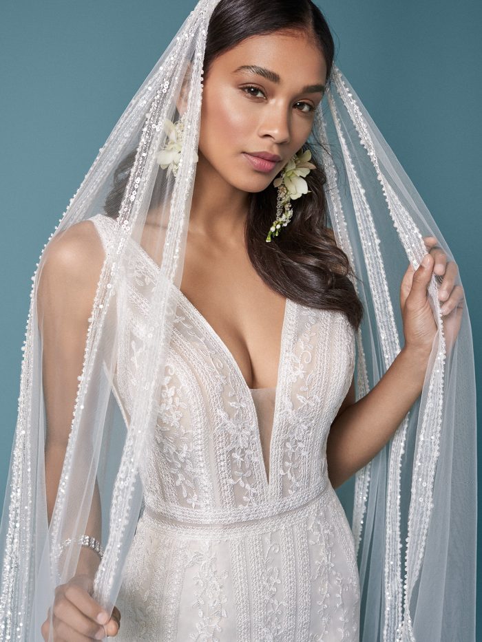 Model Wearing Lace V-neck Wedding Dress with Lace Vintage Wedding Veil Called Coretta by Maggie Sottero