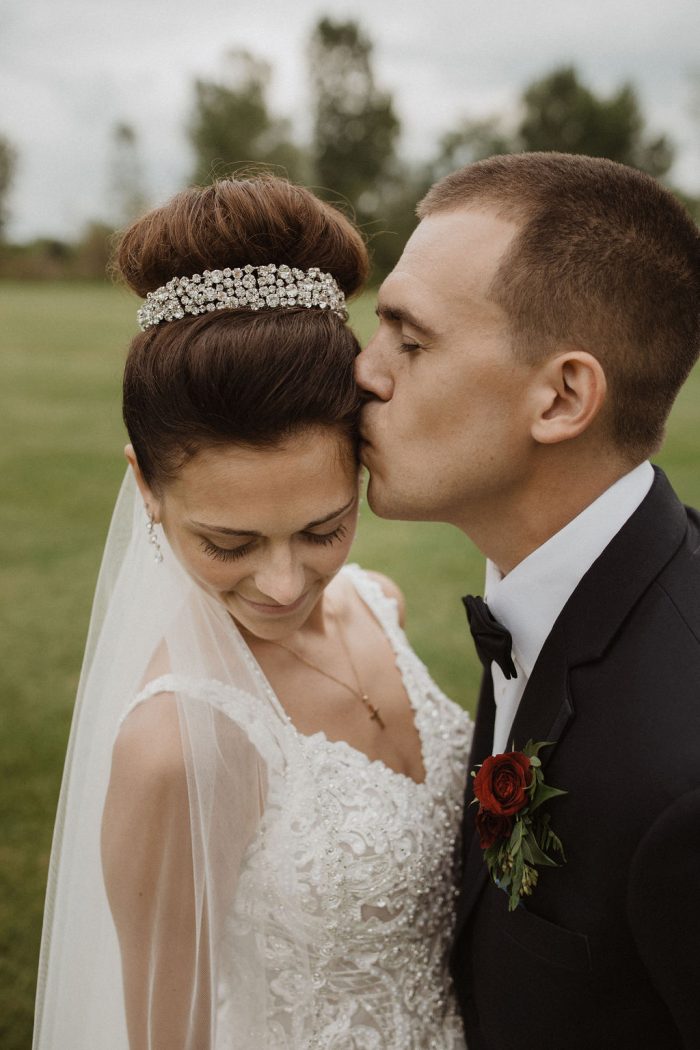 Groom Kissing Real Bride Wearing Crown and Princess Wedding Dress Called Taylor Lynette by Maggie Sottero