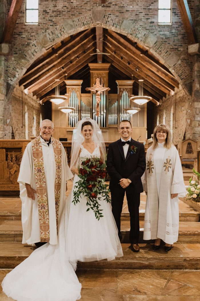 Bride and Groom Standing with Priest and Pastor at Ceremony