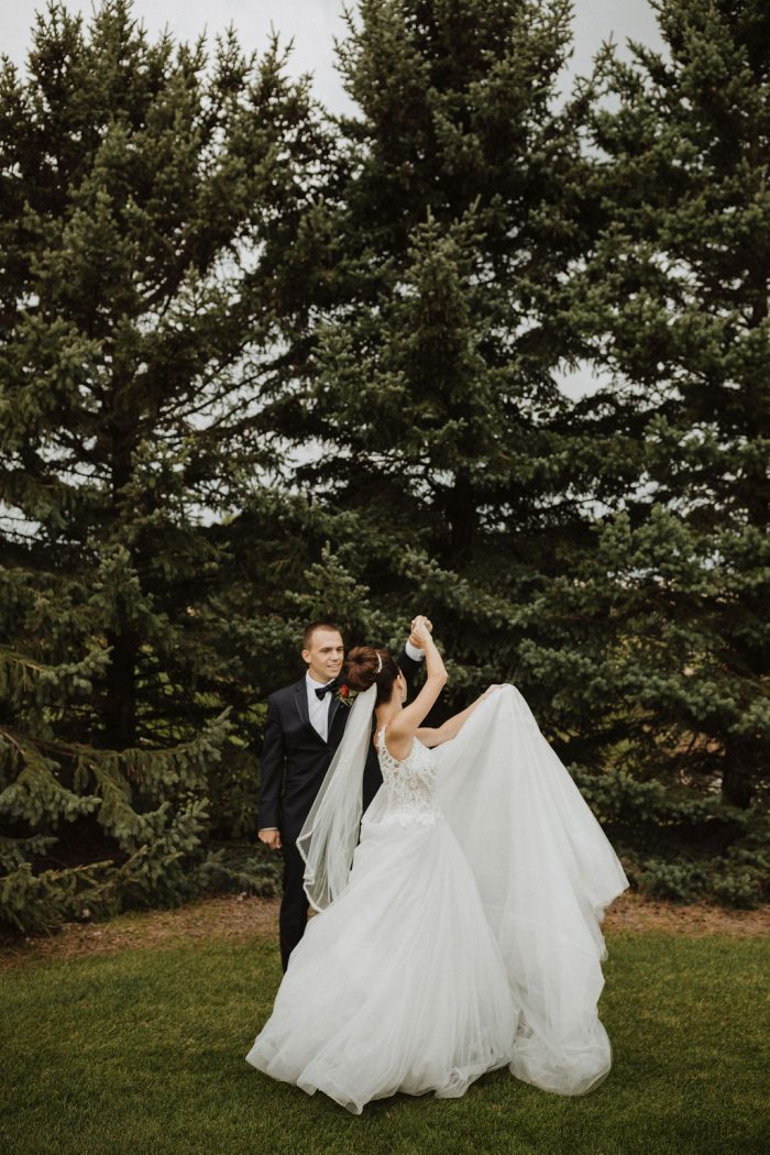 Groom Spinning Bride Wearing Ball Gown Wedding Dress Called Taylor Lynette by Maggie Sottero