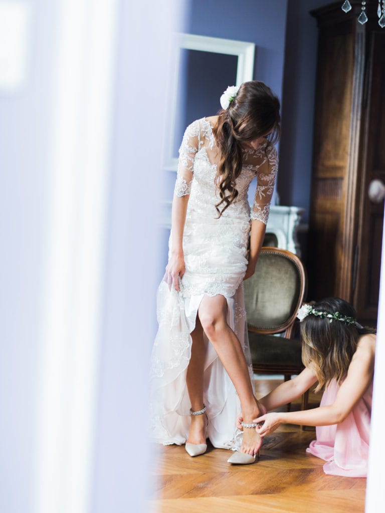 Bride Putting on Heels to Try on Wedding Dresses