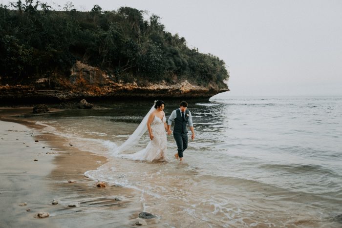 Groom with Bride Walking on Beach at Romantic Destination Wedding of Bali Indonesia