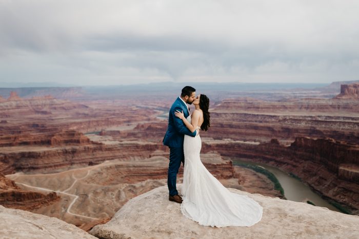 Groom Kissing Real Bride in Maggie Sottero Wedding Dress at Dead Horse Point in Moab Utah