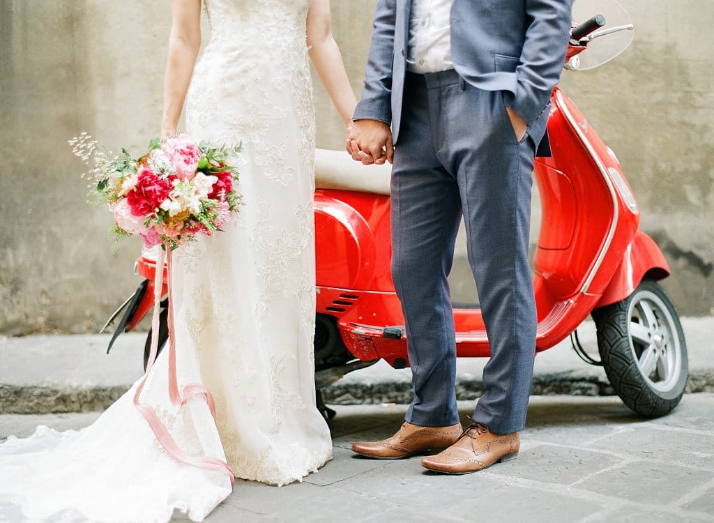 Groom with Real Bride in Front of Vespa at Real Wedding in Florence Italy