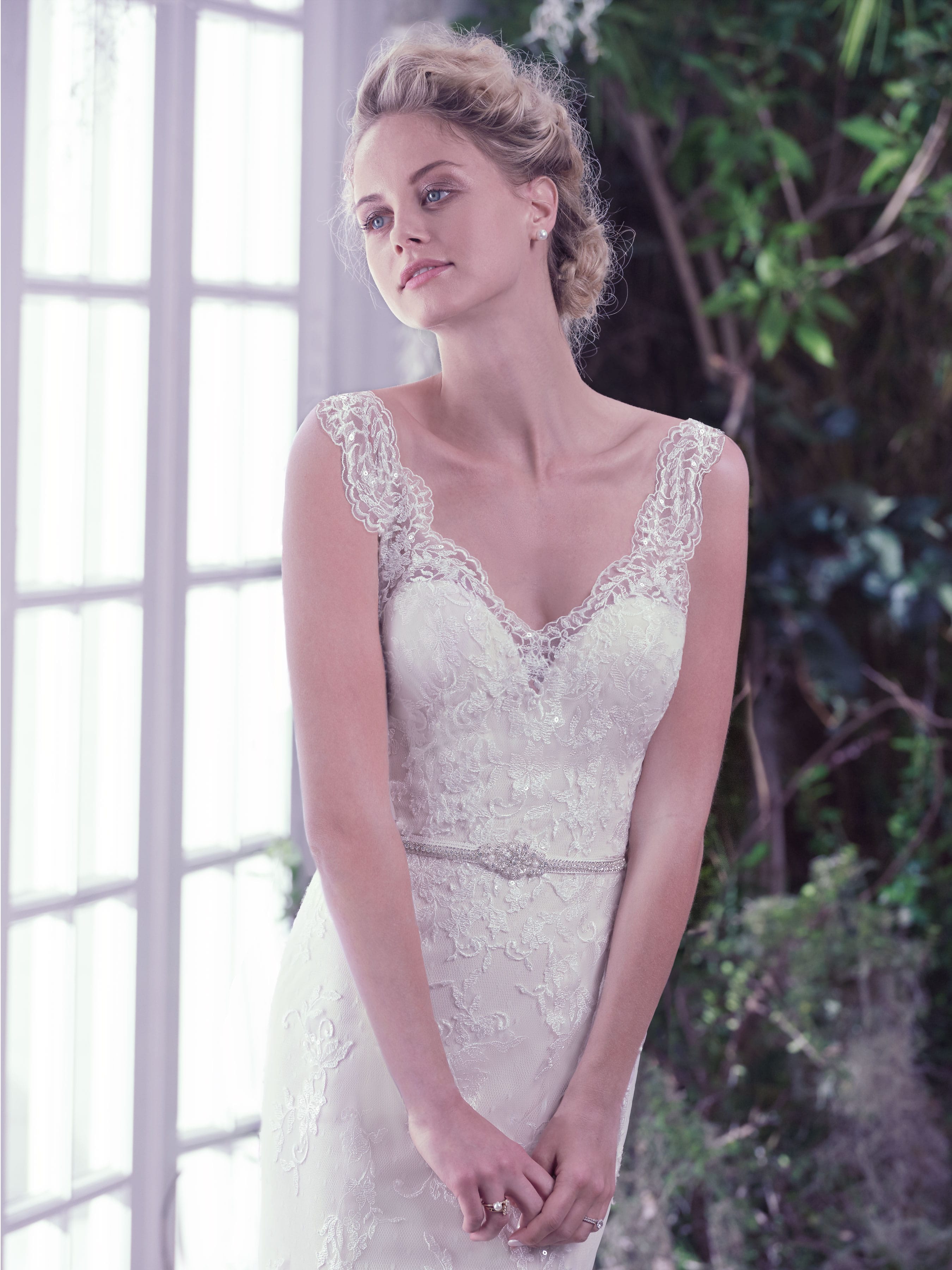 Roberta by Maggie Sottero features sheer lace sleeves and an illusion V-neck over sweetheart neckline.