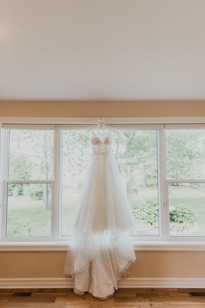Sparkly Ball Gown Wedding Dress Called Taylor by Maggie Sottero Hanging from Window