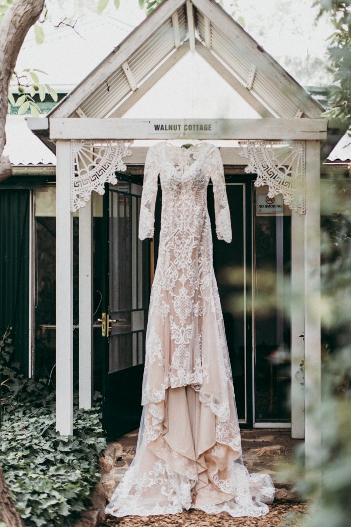 Long Sleeve Lace Wedding Dress Hanging from Doorway Called Dakota by Sottero and Midgley