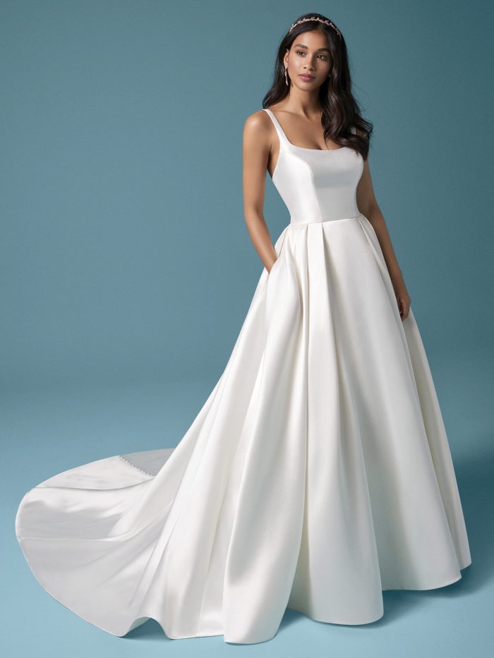 Model Wearing Satin Ball Gown Wedding Dress with Pockets Called Selena Made by Maggie Sottero