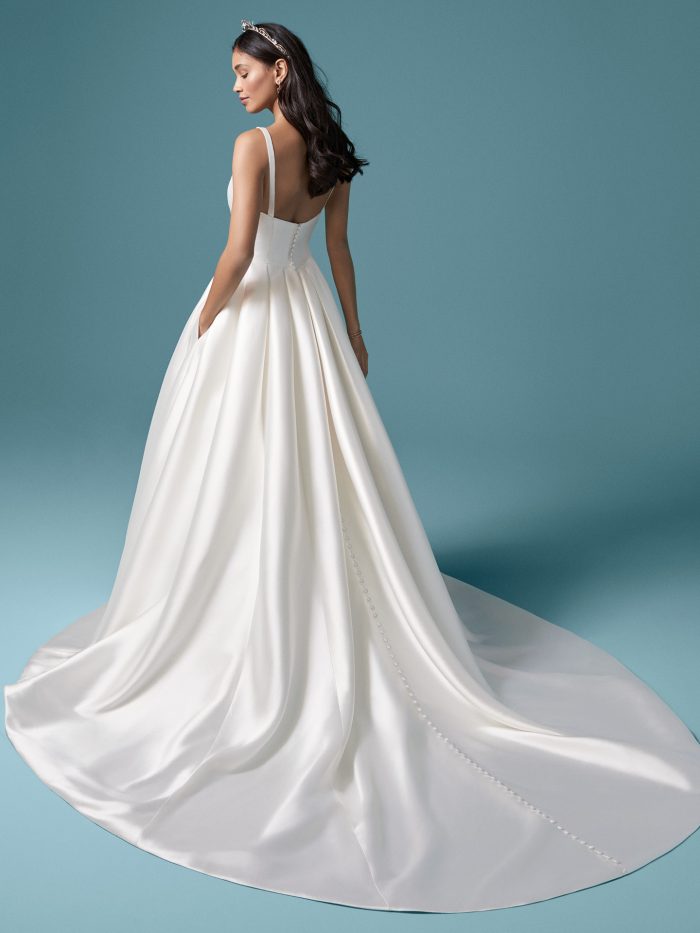 Model Wearing Satin Ball Gown Wedding Dress with Pockets Called Selena Made by Maggie Sottero